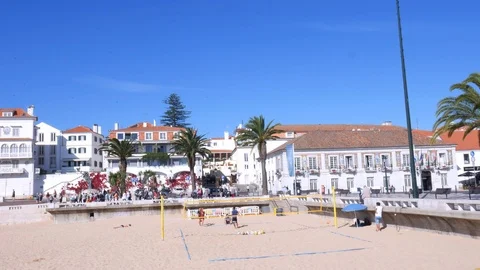 Panning of sandy Praia do Ribeiro and boats on bay a a sunny day Stock Footage 108548556
