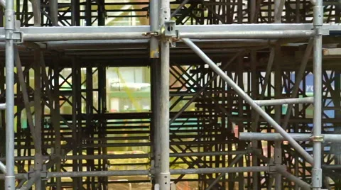 Panning scaffold structure for public construction in the middle of city Stock Footage 68994125