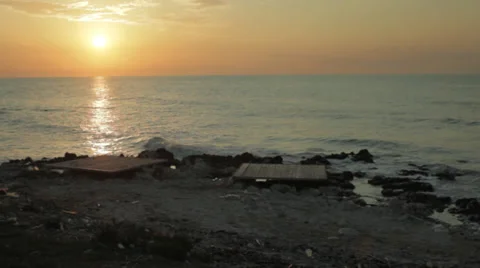 Panning of the sea from the waves to the sun at the sunset with amazing colors Stock Footage 37861155