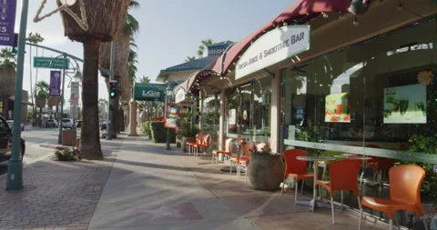 Panning on shops and restaurants in downtown Palm Springs in slow motion Stock Footage 204092276