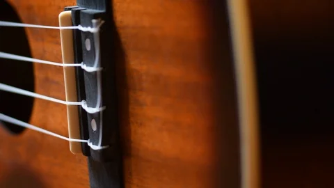 Panning shot of 4 string ukulele Stock Footage 129442485