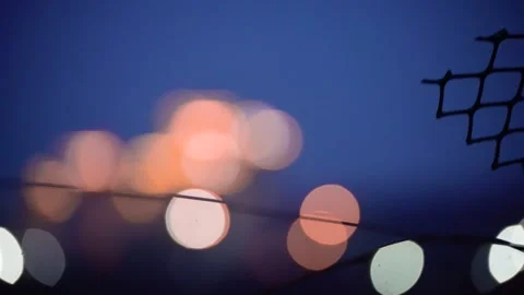 Panning shot from abstract shape of plastic mesh with out of focus lights to Stock Footage 337169727