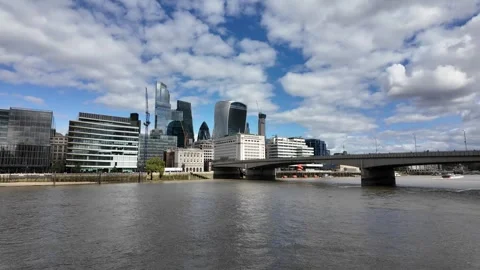 Panning shot across River Thames to City of London skyline and London Bridge Stock Footage 346677153