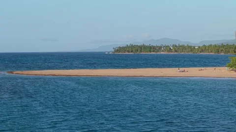 Panning Shot Across Sandy Spit and Palm Trees at Tropical Beach Stock Footage 341557282