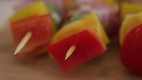 Panning shot across the sharp tips of a row of skewers 스톡 동영상 153297079