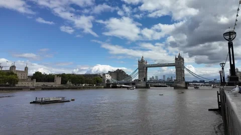 Panning shot along River Thames with Tower Bridge and cloudy sky in London Stock Footage 346677351