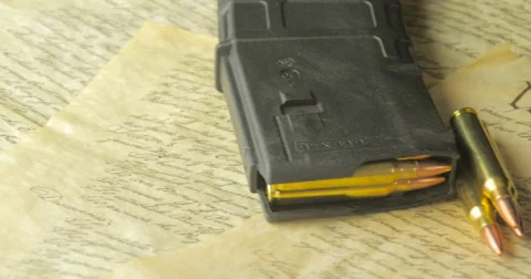 Panning Shot of Ammunition Lying on the Constitution of the USA Stock Footage 61279387