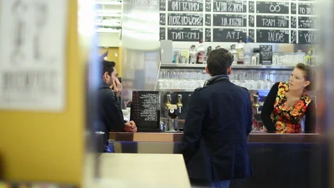 Panning Shot Of Bartender Serving Customers At Bar Counter Stock Footage 344397064