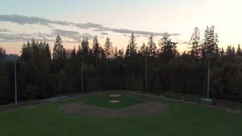 A panning up shot of a baseball diamond in a forest. 4K 24FPS Stock Footage 144409171