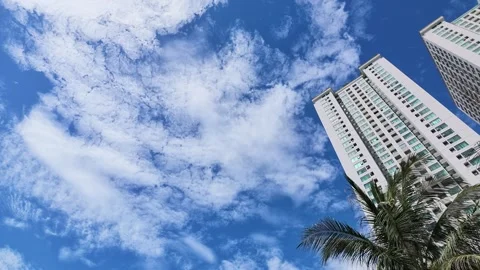 Panning Shot From Blue Sky and Clouds to Modern Skyscraper Building Stock Footage 344831523