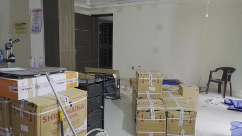 Panning shot boxes filled with home goods taped and ready to move in or out of Stock Footage 333009757