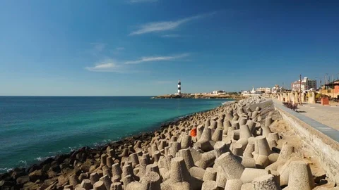 Panning shot of breakwater, lighthouse, temples near dwarka beach Gujarat india Stock Footage 101806936