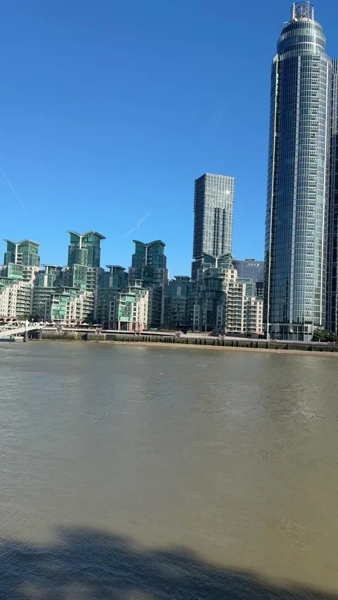 Panning Shot from Bridge to Modern Riverside Architecture in London Stock Footage 343579829