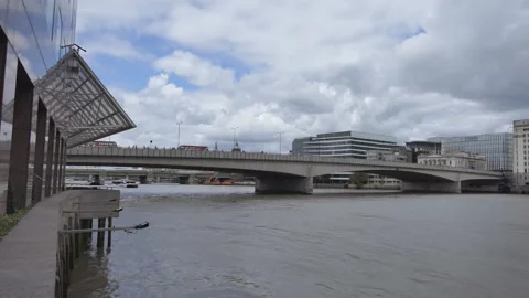 Panning shot of a bridge on Thames river and buildings on the riverside. Stock Footage 94190323