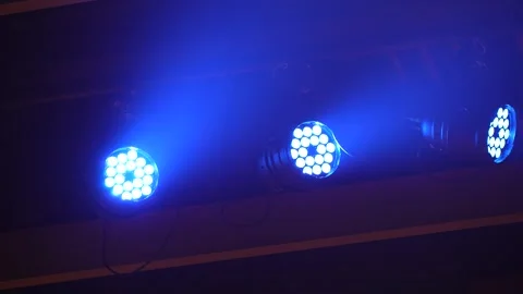 Panning shot of bright blue LED stage lights with beams in smoke Stock Footage 346355275
