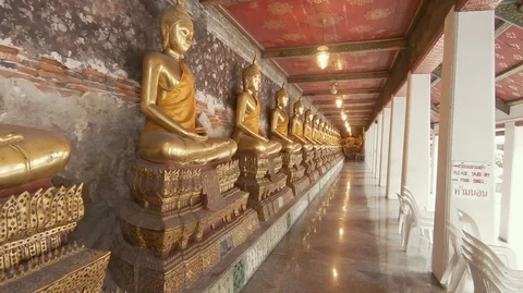Panning Shot of Buddha Statues Sitting at Wat Suthatthepwararam Temple Bangkok Stock Footage 100338552