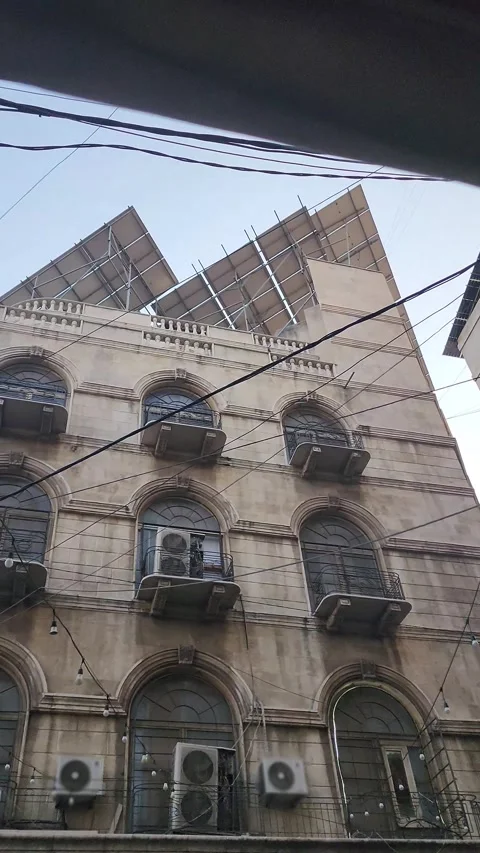 A panning shot up a building facade with solar panels Stock Footage 314500575