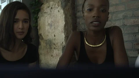 Panning shot of business professionals using laptop while discussing work Stock Footage 114855891