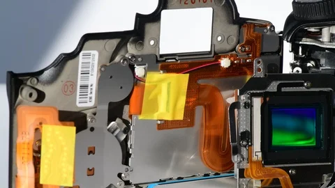 Panning shot of ccd sensor and digital slr camera showing shutter mechanism Stock Footage 123459830