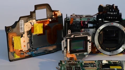Panning shot of ccd sensor and digital slr camera showing shutter mechanism Stock Footage 123544129