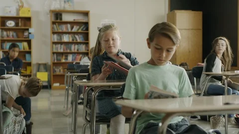 Panning shot of children preparing for start of class in elementary school Stock Footage 85911060