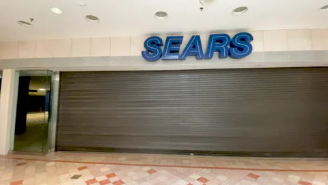 Panning shot of a closed Sears store Stock Footage 168763986