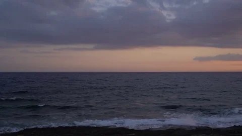 Panning shot of cloudy sky and stunning sunset over the Mediterranean sea Vídeo Stock 76988563