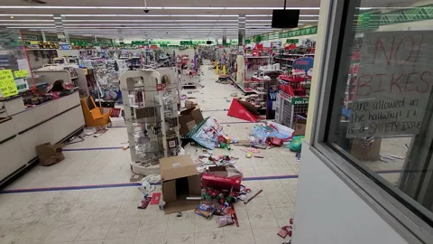 Panning shot of a cluttered store after looters robbed the store during Stock Footage 231336594