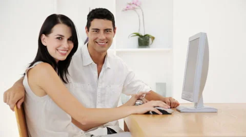 Panning Shot of Couple using Home Computer Stock Footage 912245