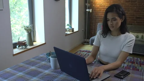 Panning shot of creative freelancer checking mobile while working in office home Stock Footage 114854935