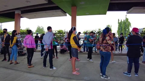 Panning shot of a crowded queue wearing a mask. Keeping social distancing Stock Footage 169003251