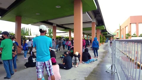Panning shot of a crowded queue wearing a mask. Keeping social distancing Stock Footage 169019379
