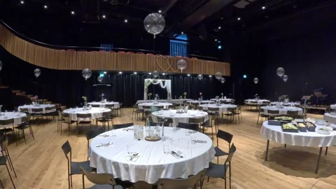 Panning shot of the decorated event hall in Varpio cultural center, Klaksvik Stock Footage 340082447