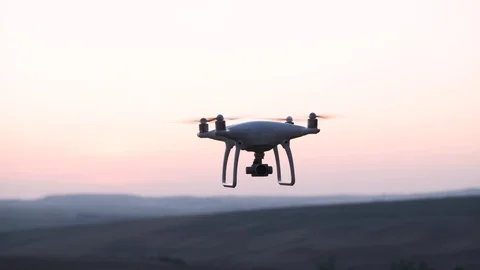 Panning Shot Of Drone Silhouette Hovering In The Air On Sunset Stock Footage 116672603