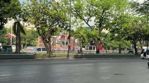Panning shot of an e-trike driving past Liwasang Bonifacio Manila 4K 스톡 동영상 337458742
