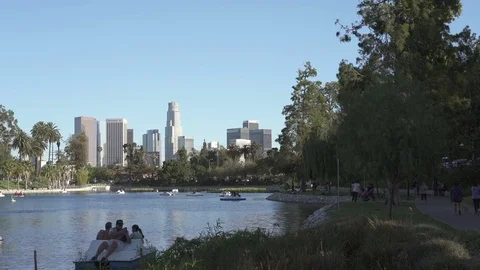 Panning shot of Echo Park Lake with downtown Los Angeles skyline Stock Footage 75881792