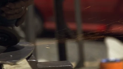 Panning shot electric circular disc grinding on metal causing sparks Stock Footage 90268264