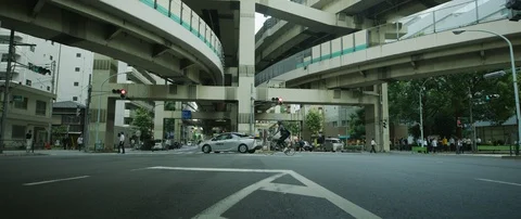 Panning shot of elevated roads above crossroad during cloudy day, Tokyo Stock Footage 136153906