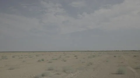 Panning shot of empty deserted fields during the day Stockbeeldmateriaal 251840442