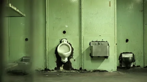 Panning shot of empty green prison cell 스톡 동영상 191353787