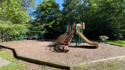 Panning Shot of Empty Playground in Sunny Green Park Vidéo 344812764