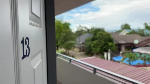 Panning shot ending on close-up of room number 13 on door. Vidéo 334784706