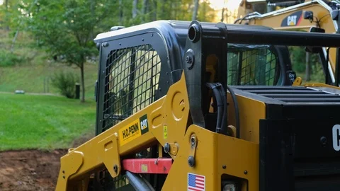 Panning Shot of an Excavator and Skid Steer During a Construction Project Stock Footage