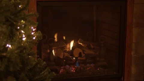 A panning shot with a focus pull of Christmas tree with lights infront of a Stock Footage 120288684
