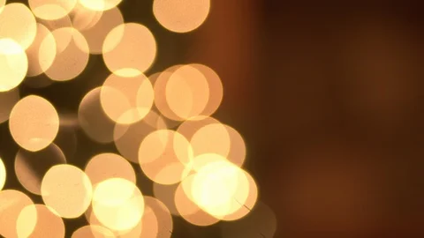A panning shot with a focus pull of Christmas tree with lights infront of a Video stock 120293088