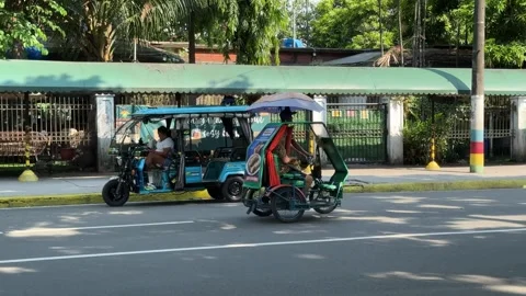 Panning shot focused on a local pedicab sikad driving to Intramuros 4K Stock Footage 337458622