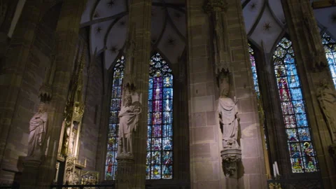 Panning shot of a gothic cathedral interior with stained glass windows and stone Vídeos de archivo 315408629