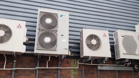 Panning shot of high level wall mounted outdoor air conditioning condenser u Stock Footage 334346321