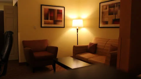 Panning shot of hotel room studio couch sitting area to desk work area. Видео 24756926