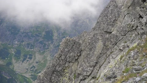 Panning shot of huge rock face and valley below in the Tatras, Slovakia. 4k Stock Footage 168346743